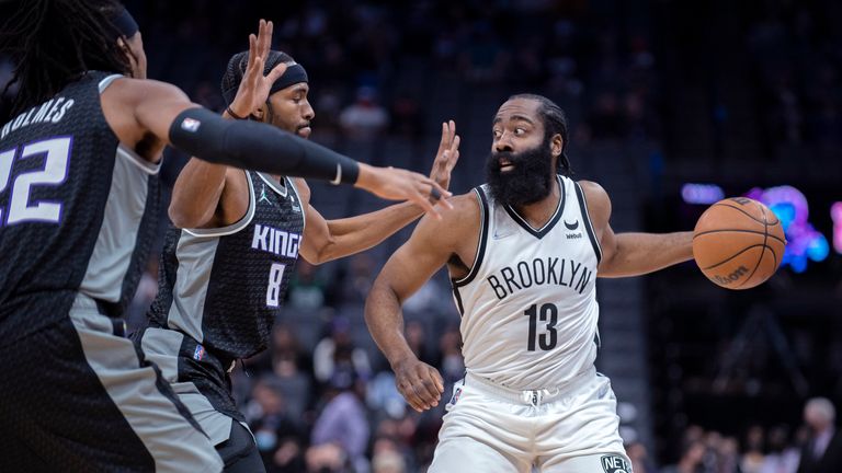 Brooklyn Nets guard James Harden (13) is double teamed by Sacramento Kings forward Maurice Harkless (8) and teammate center Richaun Holmes (22) in the first quarter of an NBA basketball game in Sacramento, Calif., Wednesday, Feb. 2, 2022. (AP Photo/Jos.. Luis Villegas)