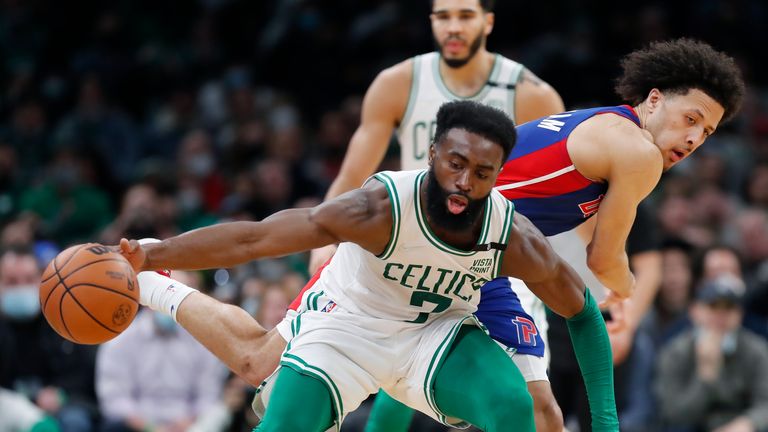 Boston Celtics&#39; Jaylen Brown (7) regains control of the ball against Detroit Pistons&#39; Cade Cunningham during the second half of an NBA basketball game, Wednesday, Feb. 16, 2022, in Boston