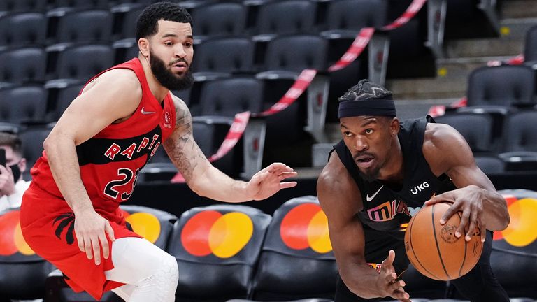 Miami Heat forward Jimmy Butler drives past Toronto Raptors guard Fred VanVleet (23) during the second half of an NBA basketball game Tuesday, Feb. 1, 2022, in Toronto.