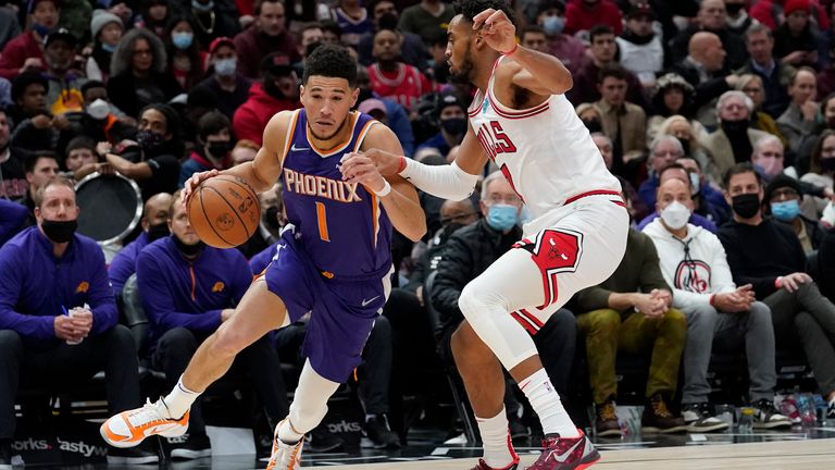 Phoenix Suns&#39; Devin Booker (1) drives to the basket as Chicago Bulls&#39; Troy Brown Jr. defends during the second half of an NBA basketball game Monday, Feb. 7, 2022, in Chicago. The Suns won 127-124. (AP Photo/Charles Rex Arbogast)


