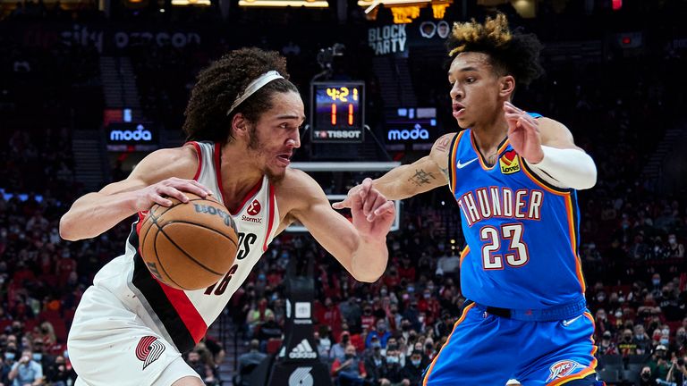 Portland Trail Blazers guard CJ Elleby, left, is defended by Oklahoma City Thunder guard Tre Mann during the first half of an NBA basketball game in Portland, Ore., Friday, Feb.  4, 2022.