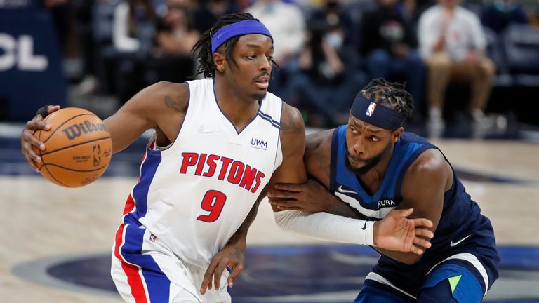 Detroit Pistons forward Jerami Grant (9) goes around Minnesota Timberwolves guard Patrick Beverly in the fourth quarter of an NBA basketball game, Sunday, Feb. 6, 2022, in Minneapolis. The Timberwolves won 118-105