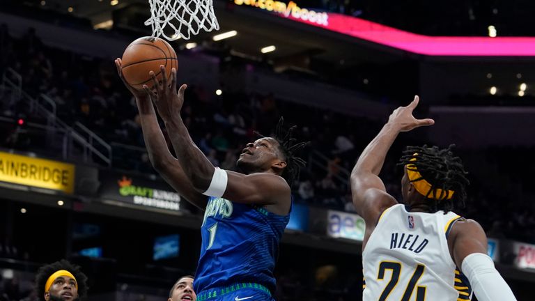 Minnesota Timberwolves&#39; Anthony Edwards (1) shoots against Indiana Pacers&#39; Buddy Hield (24) during the first half of an NBA basketball game