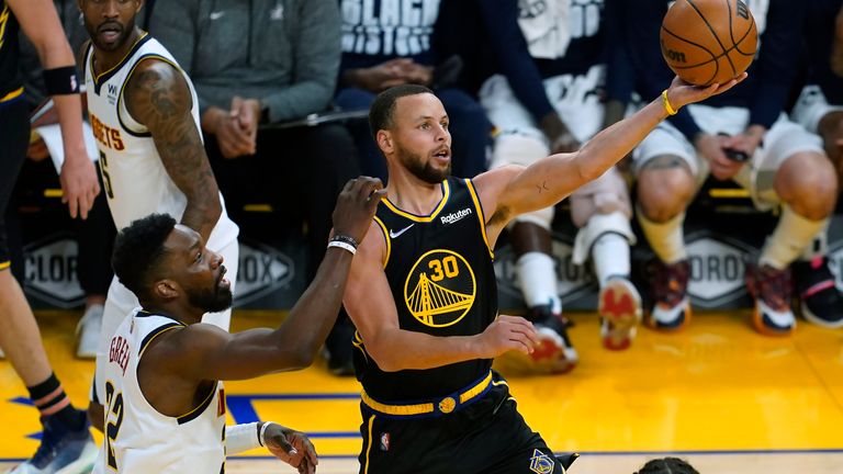 Golden State Warriors guard Stephen Curry (30) shoots next to Denver Nuggets forward Jeff Green during the second half of an NBA basketball game in San Francisco