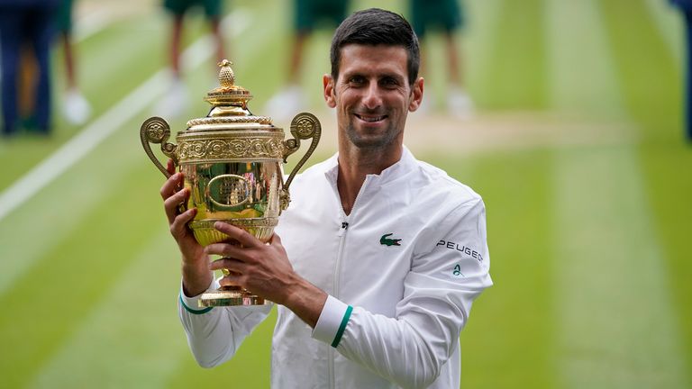 Novak Djokovic holds the trophy after his win over Italy&#39;s Matteo Berrettini in the men&#39;s singles final match of the Wimbledon Tennis Championships in London. Djokovic is 26-0 in Grand Slam matches in 2021, moving him two victories away from being the first man to win all four major tennis championships in one season since Rod Laver in 1969. (AP Photo/Alberto Pezzali, Pool)