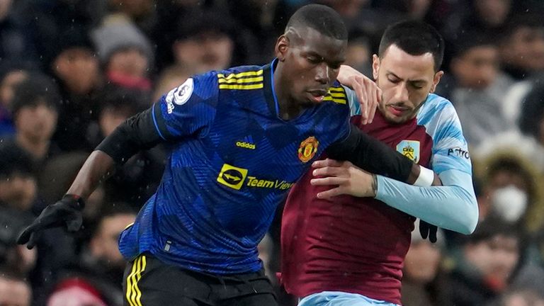 Manchester United's Paul Pogba competes for the ball with Burnley's Dwight McNeil (AP)