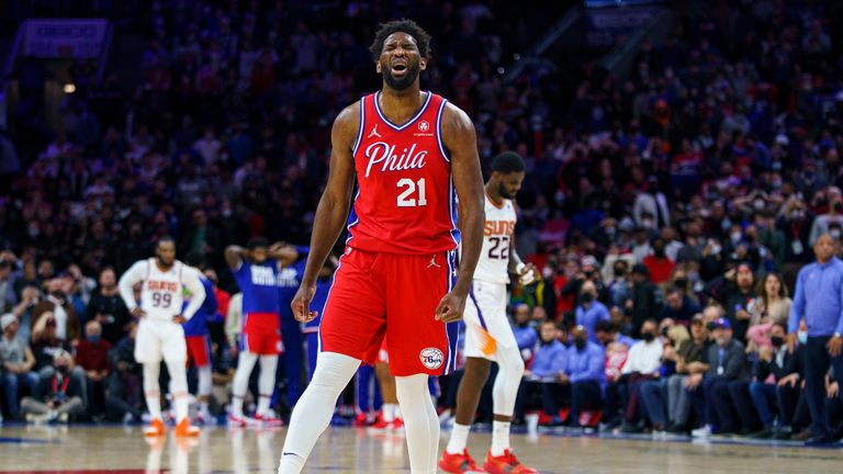Philadelphia 76ers' Joel Embiid reacts to his pass going out-of-bounds during the second half of an NBA basketball game against the Phoenix Suns