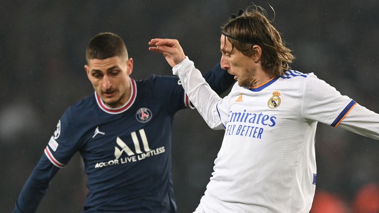 Real Madrid's Luka Modric is challenged by PSG's Marco Verratti