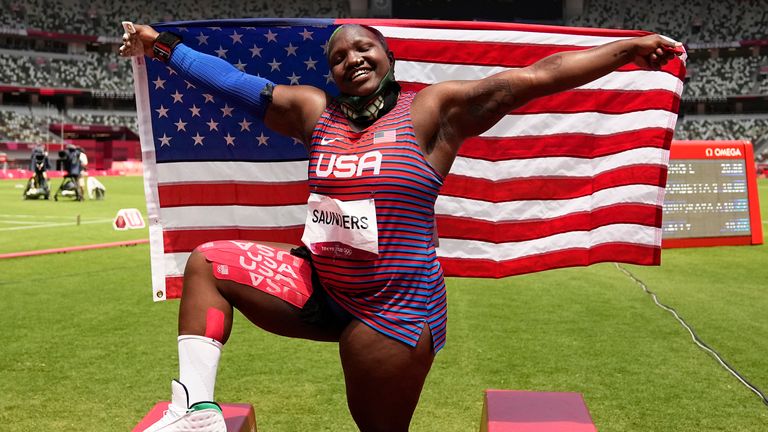 Saunders with the United States flag after finishing second in the women's shot put in the Olympics