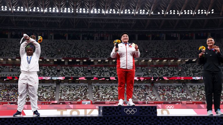 Saunders (left) protests on the podium after receiving her Olympic silver medal in the women's shot put in Tokyo 