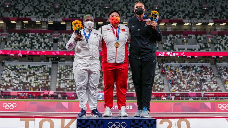 China's Lijia Gong, center, poses with her gold medal after winning women's shot put next to Raven Saunders, of the United States, left, silver medal, and New Zealand's Valerie Adams, bronze medal