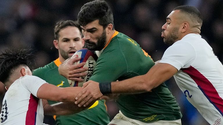 South Africa's Damian de Allende, centre, on the charge during an international rugby union match against England