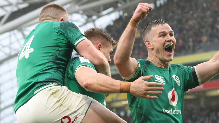 Jonathan Sexton celebrates with Ireland's Andrew Conway and try-scorer Garry Ringrose