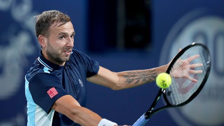 Daniel Evans of Britain returns the ball to Andrey Rublev of Russia during a match at the Dubai Duty Free Tennis Championship in Dubai, United Arab Emirates