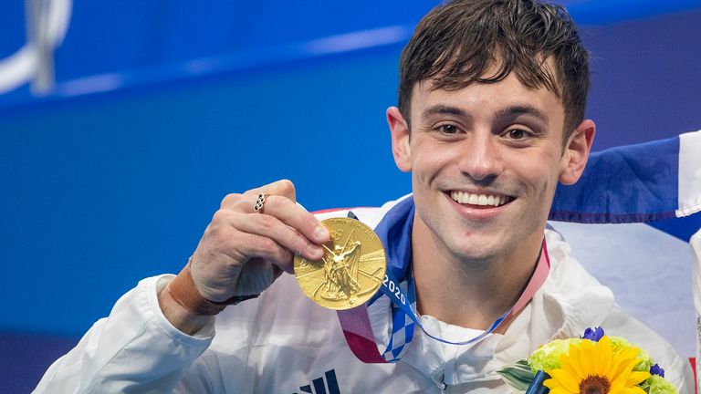 TOKYO, JAPAN - JULY 26: Tom Daley of Great Britain with his gold medal won with team mate Matty Lee of Great Britain in the Men's Synchronised 10m Platform Diving at the Tokyo Aquatic Centre at the Tokyo 2020 Summer Olympic Games on July 26, 2021 in Tokyo, Japan. (Photo by Tim Clayton/Corbis via Getty Images)