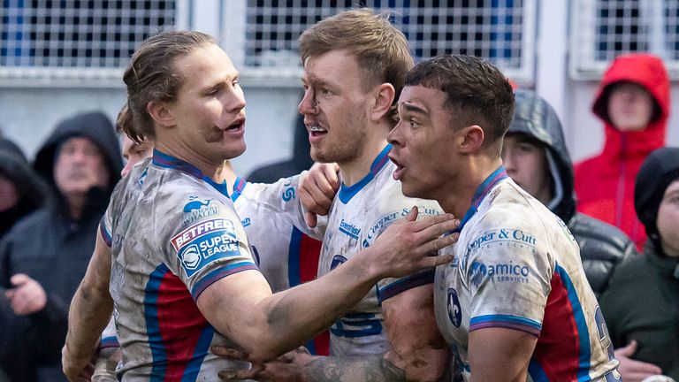 Picture by Allan McKenzie/SWpix.com - 13/02/2022 - Rugby League - Betfred Super League Round 1 - Wakefield Trinity v Hull FC - Beaumont Legal Stadium, Wakefield, England - Wakefield's Tom Johnstone (c) is congratulated on a try against Hull FC by Jacob MIller & Corey Hall.