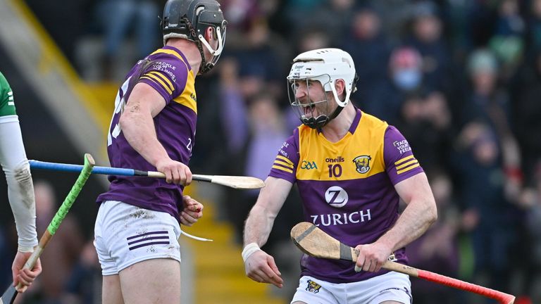 6 February 2022; William O...Donoghue of Limerick looks on as Mikie Dwyer of Wexford celebrates with team mate Ois..n Foley after scoring a goal, in the 23rd minute of the second half, during the Allianz Hurling League Division 1 Group A match between Wexford and Limerick at Chadwicks Wexford Park in Wexford. Photo by Ray McManus/Sportsfile
