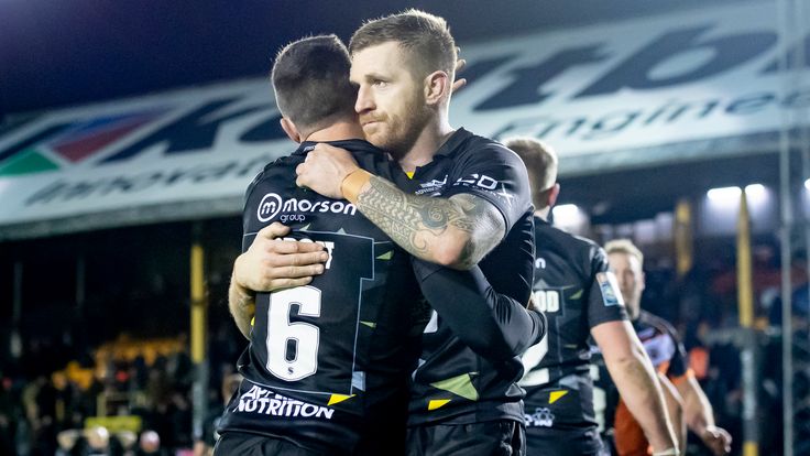 Picture by Allan McKenzie/SWpix.com - 11/02/2022 - Rugby League - Betfred Super League Round 1 - Castleford Tigers v Salford Red Devils - the Mend A Hose Jungle, Castleford, England - Brodie Croft & Marc Sneyd celebrate victory.