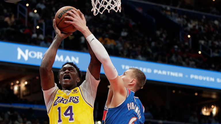Los Angeles Lakers Stanley Johnson is fouled by Washington Wizards&#39; Kristaps Porzingis during the second half of an NBA basketball game Saturday, March 19, 2022, in Washington.