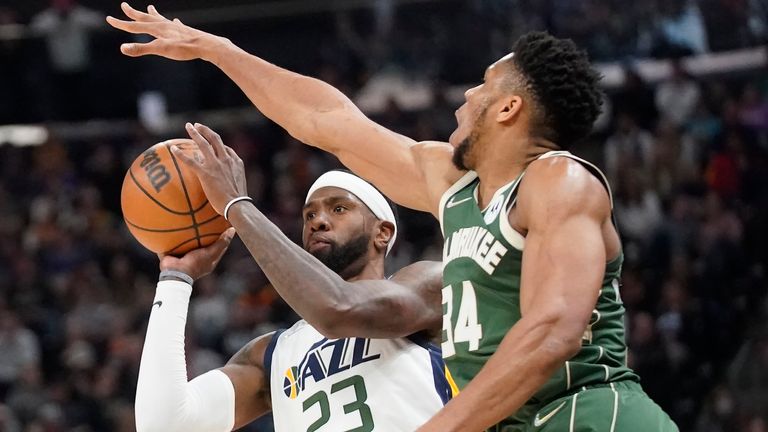 Milwaukee Bucks forward Giannis Antetokounmpo (34) defends against Utah Jazz forward Royce O'Neale (23) during the first half of an NBA basketball game Monday, March 14, 2022, in Salt Lake City.