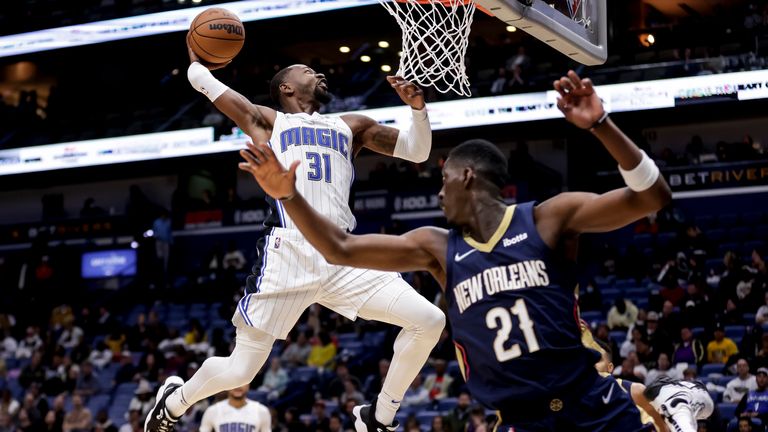 Orlando Magic guard Terrence Ross (31) dunks next to New Orleans Pelicans forward Tony Snell (21) during the second half of an NBA basketball game in New Orleans, Wednesday, March 9, 2022.