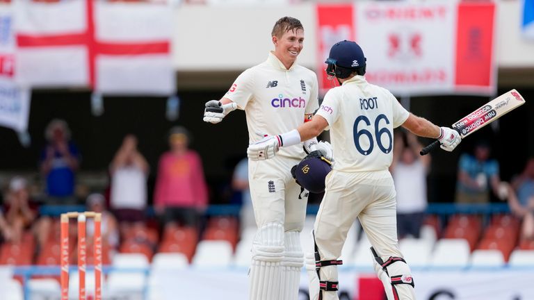 England&#39;s Zak Crawley celebrates with captain Joe Root after scoring a century against West Indies during day four of the first cricket Test match at the Sir Vivian Richards Cricket Ground in North Sound, Antigua and Barbuda, Friday, March 11, 2022.