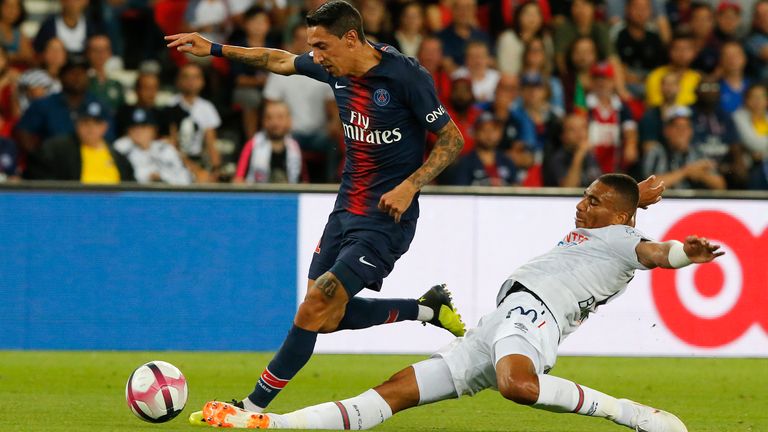 PSG's Angel Di Maria, left, challenge for the ball with Caen's Alexander Djiku in 2018 (pic: AP Photo/Michel Euler)