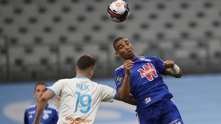 Strasbourg's Alexander Djiku, right, jumps for a header with Marseille's Arkadiusz Milik (pic: AP Photo/Daniel Cole)