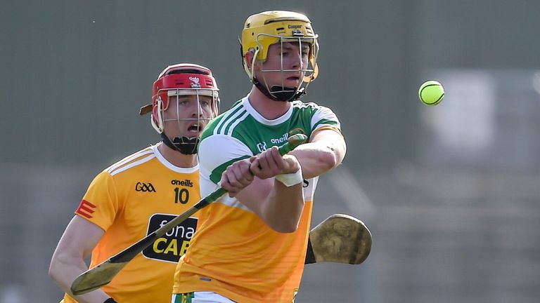 Killian Sampson of Offaly in action against James McNaughton of Antrim
