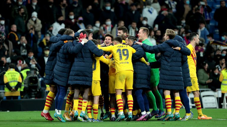 Barcelona celebrate on the pitch at the Bernabeu