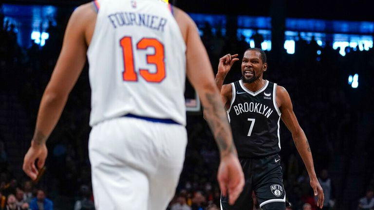 Brooklyn Nets' Kevin Durant, right, reacts after hitting a basket during the second half of the NBA basketball game against the New York Knicks at the Barclays Center, Sunday, Mar. 13, 2022, in New York. The Nets defeated the Knicks 110-107.