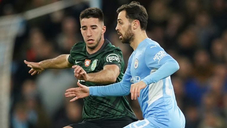 Manchester City's Bernardo Silva, right, is challenged by Sporting's Goncalo Inacio 