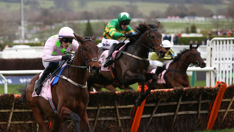 Brazil (green cap) chases down Gaelic Warrior (pink) in the Boodles Juvenile Handicap Hurdle at Cheltenham