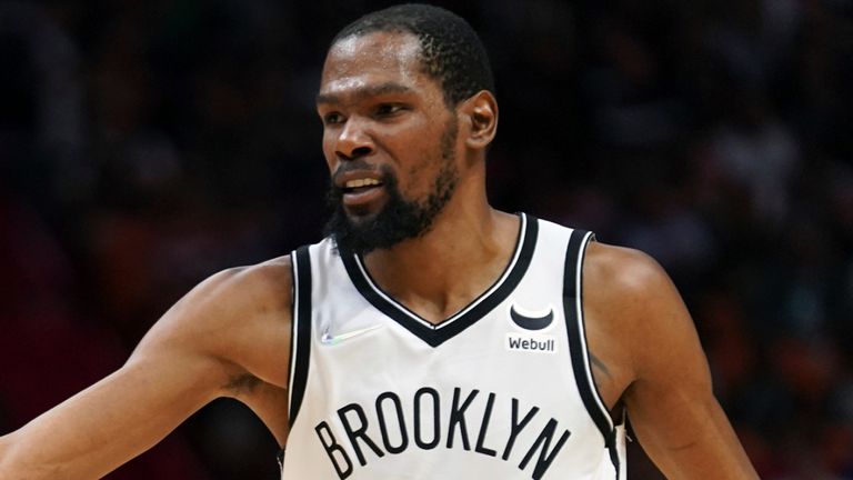 Brooklyn Nets forward Kevin Durant (7) congratulates Brooklyn Nets guard Seth Curry, left after making a three-point shot during the second half of an NBA basketball game against the Miami Heat, Saturday, March 26, 2022, in Miami. (AP Photo/Jim Rassol)
