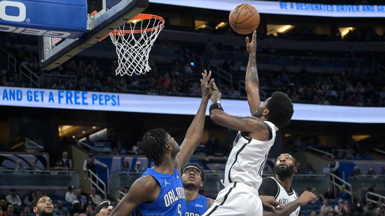 Brooklyn Nets guard Kyrie Irving shot in front of Orlando Magic center Mo Bamba and center Wendell Carter Jr.