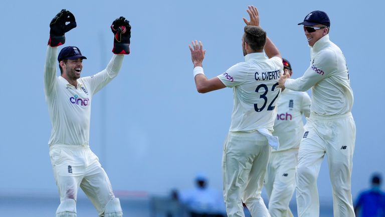 England's Ben Foakes celebrates with bowler England's Craig Overton the dismissal of West Indies' John Campbell during day two of their first cricket Test match at the Sir Vivian Richards Cricket Ground in North Sound, Antigua and Barbuda, Tuesday, March 8, 2022. (AP Photo/Ricardo Mazalan)