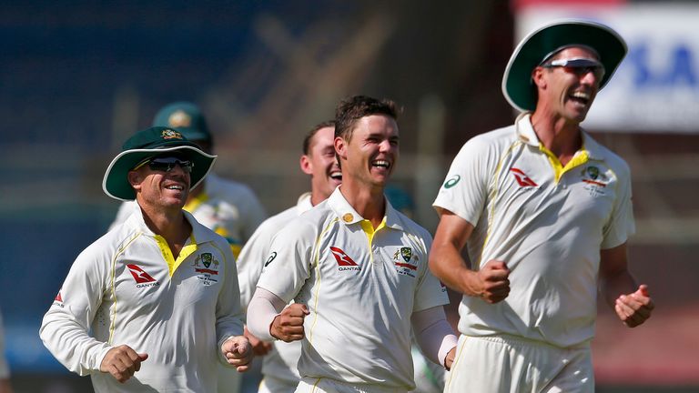 Australia's Mitchell Swepson, second right, and teammates celebrate after the dismissal of Pakistan Babar Azam on the third day of the second test match between Pakistan and Australia at the National Stadium in Karachi, Pakistan, Monday, March 14, 2022.