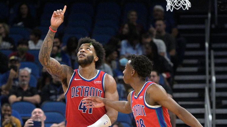 Detroit Pistons forward Saddiq Bey reacts after making a free throw near the end of the team&#39;s NBA basketball game against the Orlando Magic as Pistons guard Saben Lee congratulates him.
