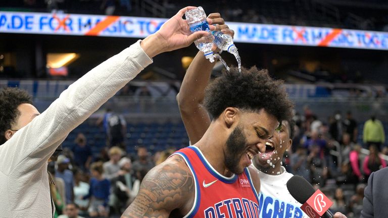 Detroit Pistons forward Saddiq Bey is doused by teammates Cade Cunningham and Hamidou Diallo after scoring 51 points in the team&#39;s NBA basketball game against the Orlando Magic