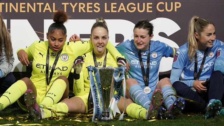 Manchester City goalkeeper Ellie Roebuck with the trophy as her team celebrate winning the The FA Women's Continental Tyres League Cup
