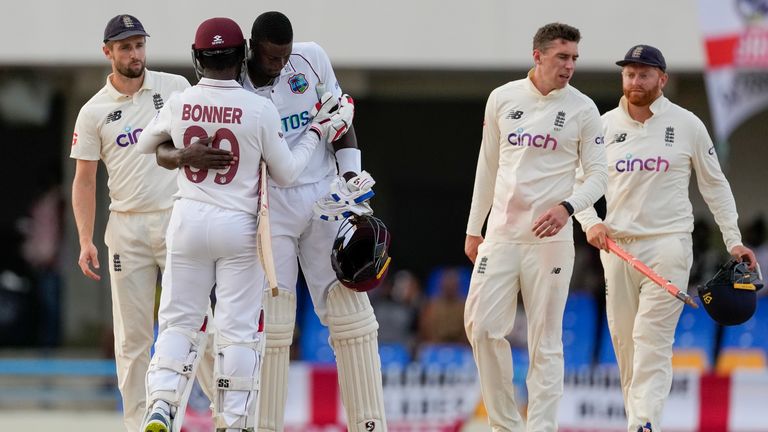 Jason Holder and Nkrumah Bonner, of West Indies, embrace after day five of their first cricket Test match against England ended in a draw at the Sir Vivian Richards Cricket Ground in North Sound, Antigua and Barbuda, Saturday, March 12, 2022. (AP Photo/Ricardo Mazalan)