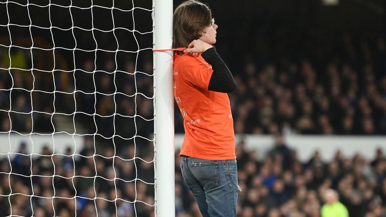 A protestor ties himself to a goal post during Everton vs Newcastle