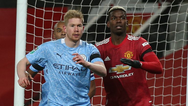 Paul Pogba of Manchester United in action with Kevin de Bruyne of Manchester City during the Carabao Cup Semi Final between Manchester United and Manchester City at Old Trafford on January 06, 2021 in Manchester, England.