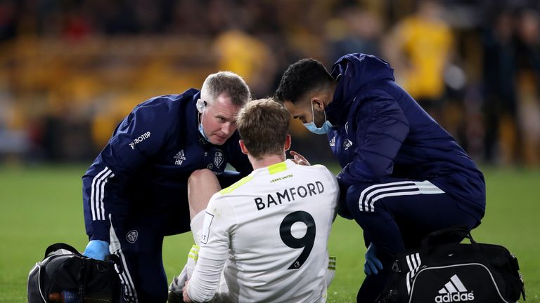 Leeds United's Patrick Bamford receives treatment before going off injured during the Premier League match at Molineux Stadium, Wolverhampton.