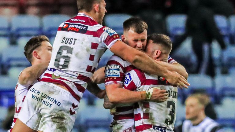 Picture by Alex Whitehead/SWpix.com - 31/03/2022 - Rugby League - Betfred Super League: Round 7 - Wigan Warriors vs Hull FC - DW Stadium, Wigan, England - Wigan’s Harry Smith, Zak Hardaker, Cade Cust and Jai Field celebrate taking the lead late on after Harry Smith kicks a drop-goal.