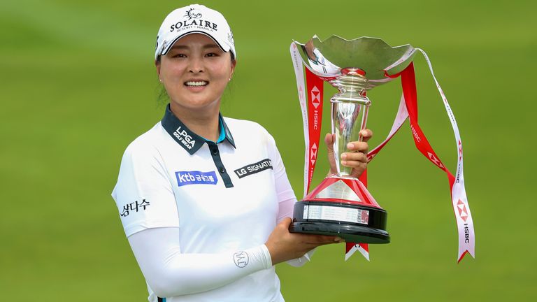 Jin Young Ko of South Korea holds the championship trophy after winning the Women's World Championship of golf at Sentosa Golf Club in Singapore