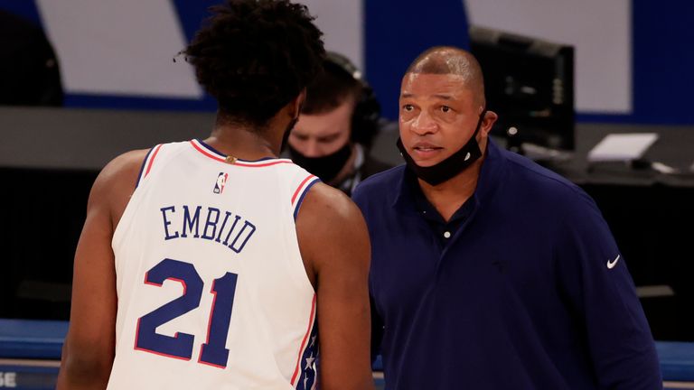 Doc Rivers passes on instructions to Joel Embiid from the sideline