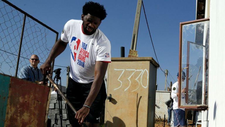 NBA Team Africa&#39;s Joel Embiid paints a newly-built house in Johannesburg, South Africa, in 2018