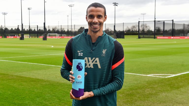Joel Matip with his Premier League player of the month trophy  - credit Andrew Powell/Liverpool FC via Getty Images