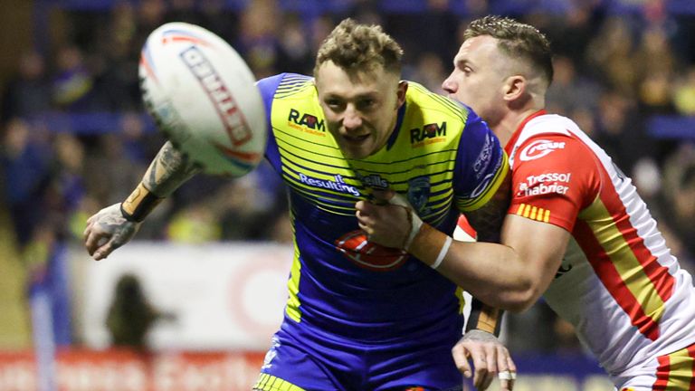 Picture by Paul Currie/SWpix.com - 04/03/2022 - Rugby League - Betfred Super League Round 4 - Warrington Wolves v Catalans Dragons - Halliwell Jones Stadium, Warrington, England - Warrington Wolves' Josh Charnley is tackled by Catalans Dragons' Josh Drinkwater